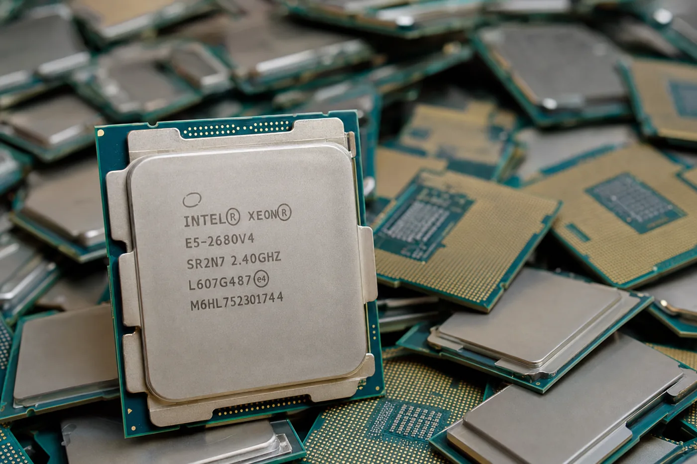 A close-up of a real Intel Xeon CPU on a pile of identical chips